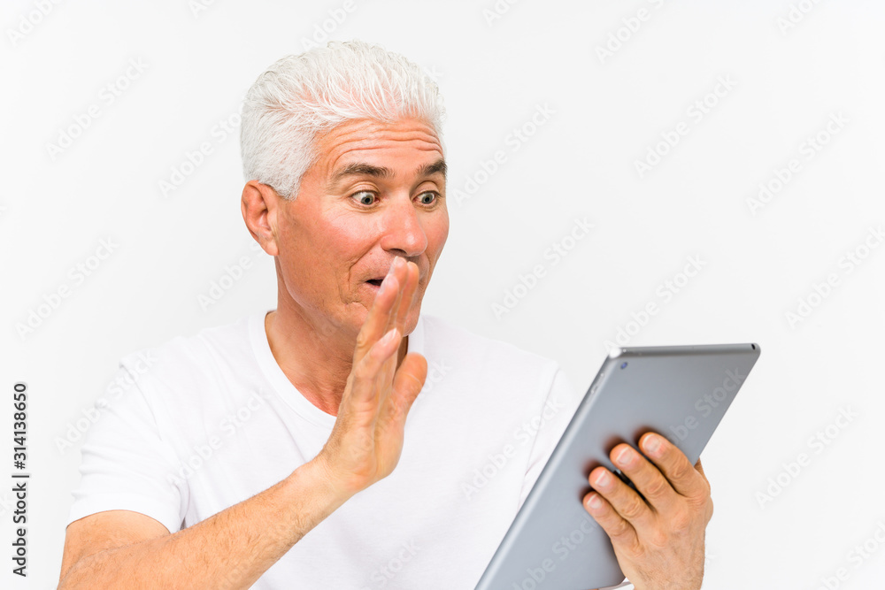 Mature caucasian man holding a tablet Mature caucasian man holding a tablet