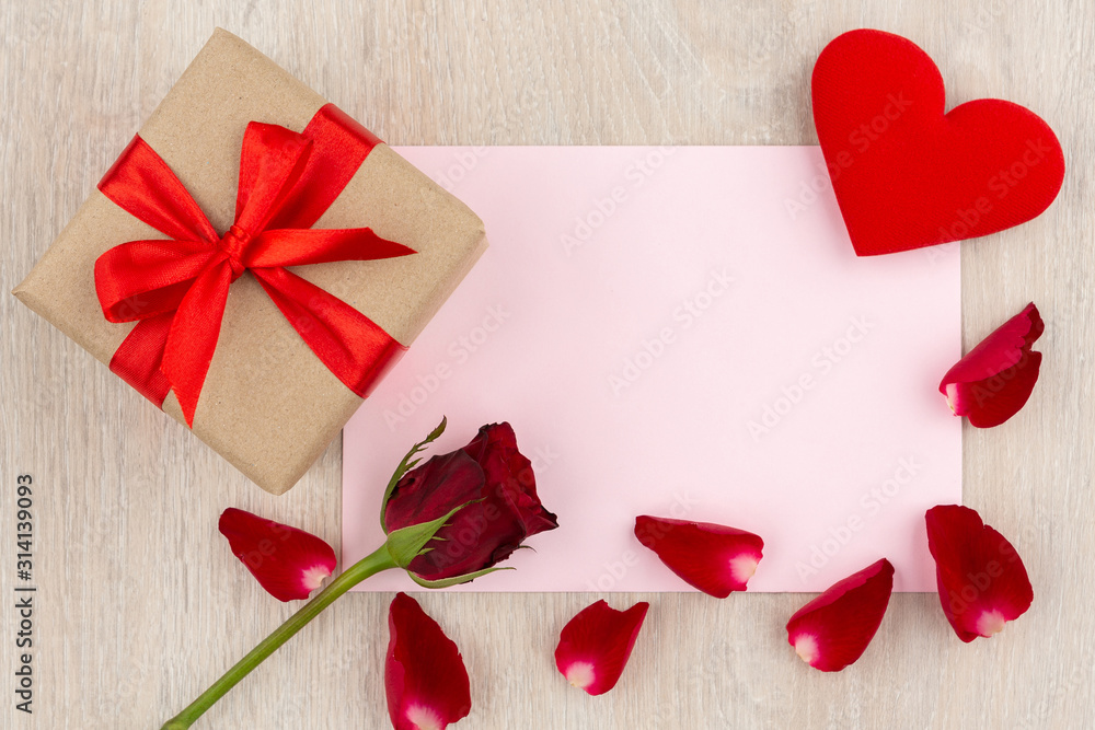 Valentine's Day Concept Gift box, heart, red rose and letter on the wooden table Valentine's Day Concept Gift box, heart, red rose and letter on the wooden table