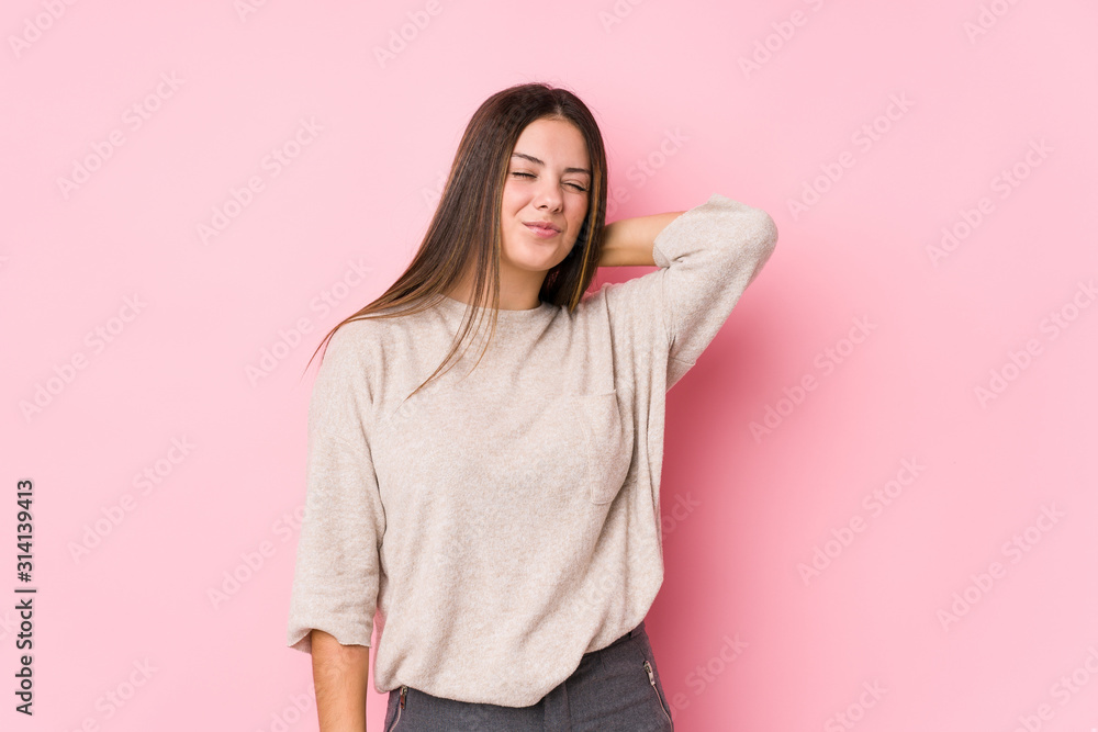 Young caucasian woman posing isolated suffering neck pain due to sedentary lifestyle. Young caucasian woman posing isolated suffering neck pain due to sedentary lifestyle.