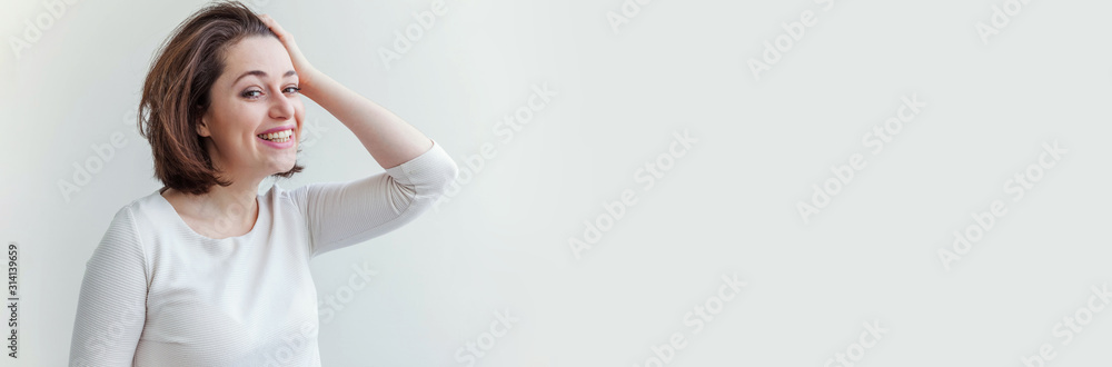 Happy girl smiling. Beauty portrait young happy positive laughing brunette woman on white background isolated. European woman. Positive human emotion facial expression body language. Banner Happy girl smiling. Beauty portrait young happy positive laughing brunette woman on white background isolated. European woman. Positive human emotion facial expression body language. Banner