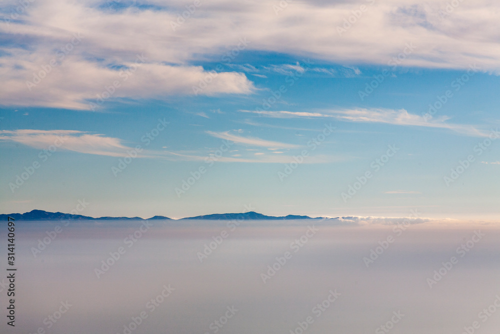 Looking over the clouds at the tops of the Channel islands in Santa Barbara, California.  