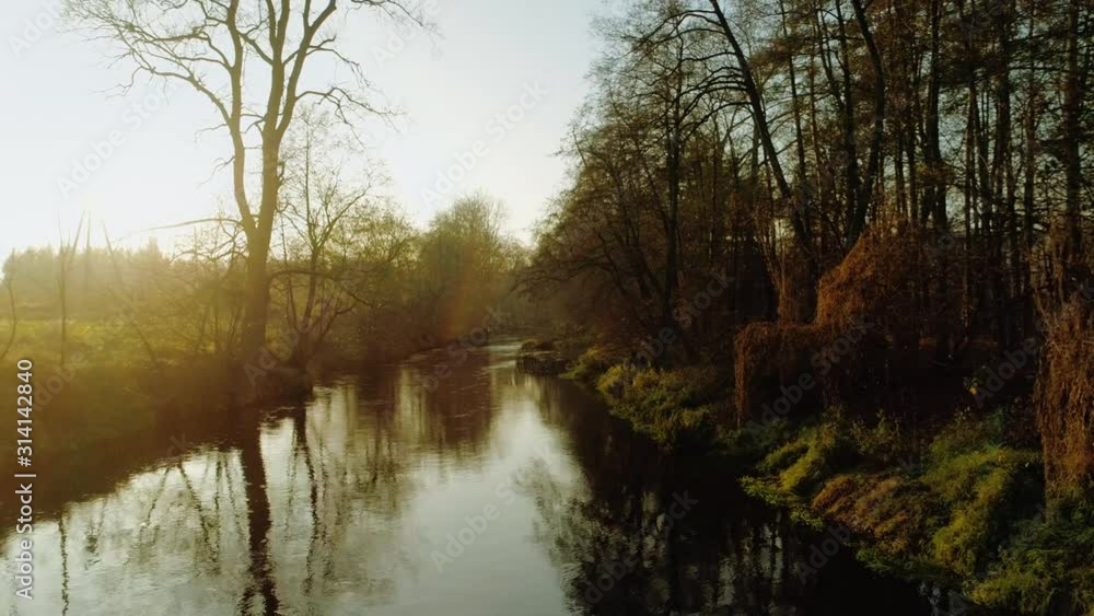 Scenic video of Polish river Wkra at sunset with gentle mist rising above water, almost fantasy scenery. Drone, aerial shot. Cinematic grading. Scenic video of Polish river Wkra at sunset with gentle mist rising above water, almost fantasy scenery. Drone, aerial shot. Cinematic grading.