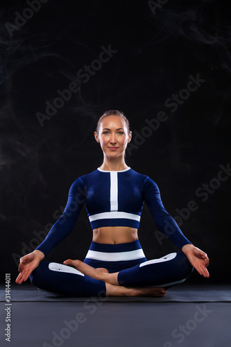 Yoga Indoor. Sports recreation. Beautiful young woman in asana pose. Individual sports.