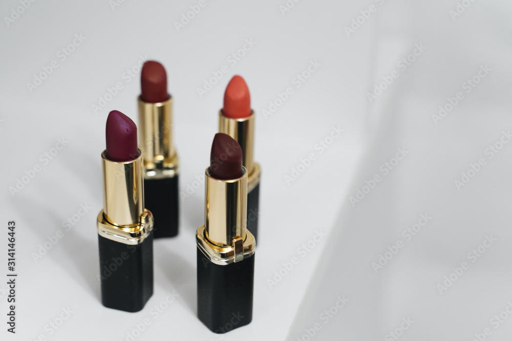 Lipsticks of different colors on wooden background Lipsticks of different colors on wooden background