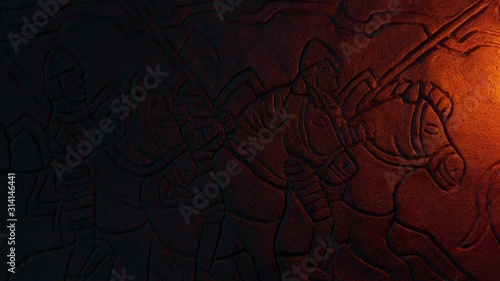 Knights On Horses Middle Ages Stone Carving In Firelight photo