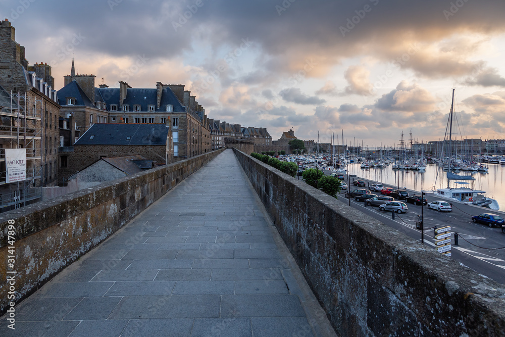View of the old houses and the fortress of Saint-Malo from the ramparts on an early summer morning. Brittany, France.