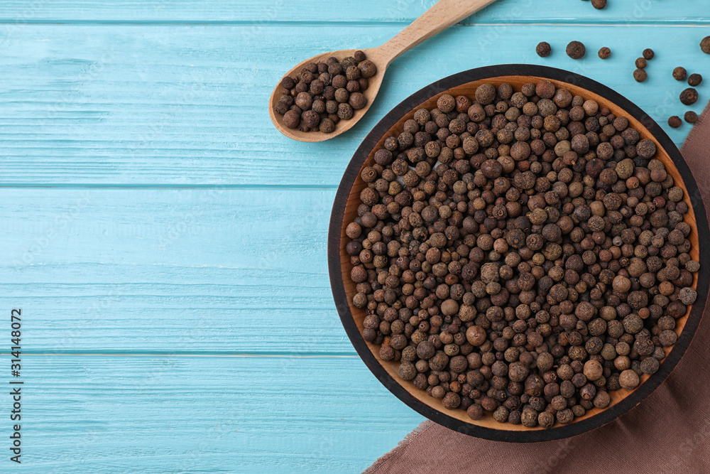 Peppercorns on light blue wooden table, flat lay. Space for text Peppercorns on light blue wooden table, flat lay. Space for text
