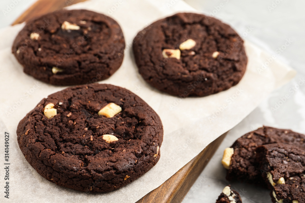 Delicious chocolate cookies on board, closeup view