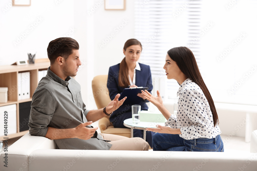 Professional psychologist working with couple in office Professional psychologist working with couple in office