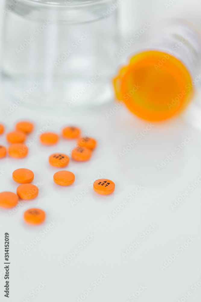 Group of assorted orange prescription pills Group of assorted orange prescription pills