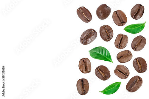 Heap of roasted coffee beans with leaves isolated on white background with copy space for your text. Top view. Flat lay.