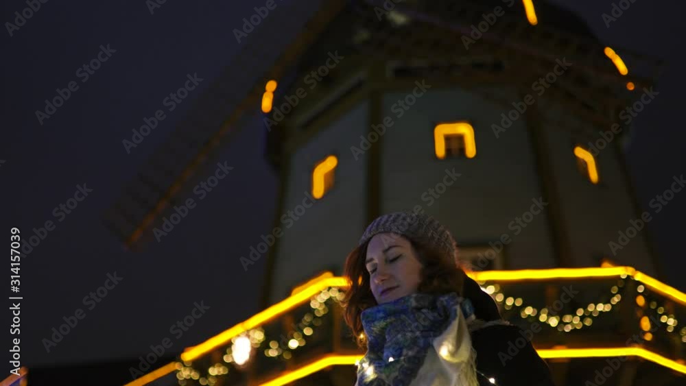Portrait: Young attractive redhead girl hanging out in amusement theme park with bright vivid colorful attractions and installations background - Eastern European winter without snow in Latvia Riga Portrait: Young attractive redhead girl hanging out in amusement theme park with bright vivid colorful attractions and installations background - Eastern European winter without snow in Latvia Riga
