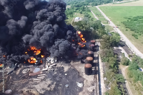 Oil storage fire. The tank farm is burning, black smoke is combu photo