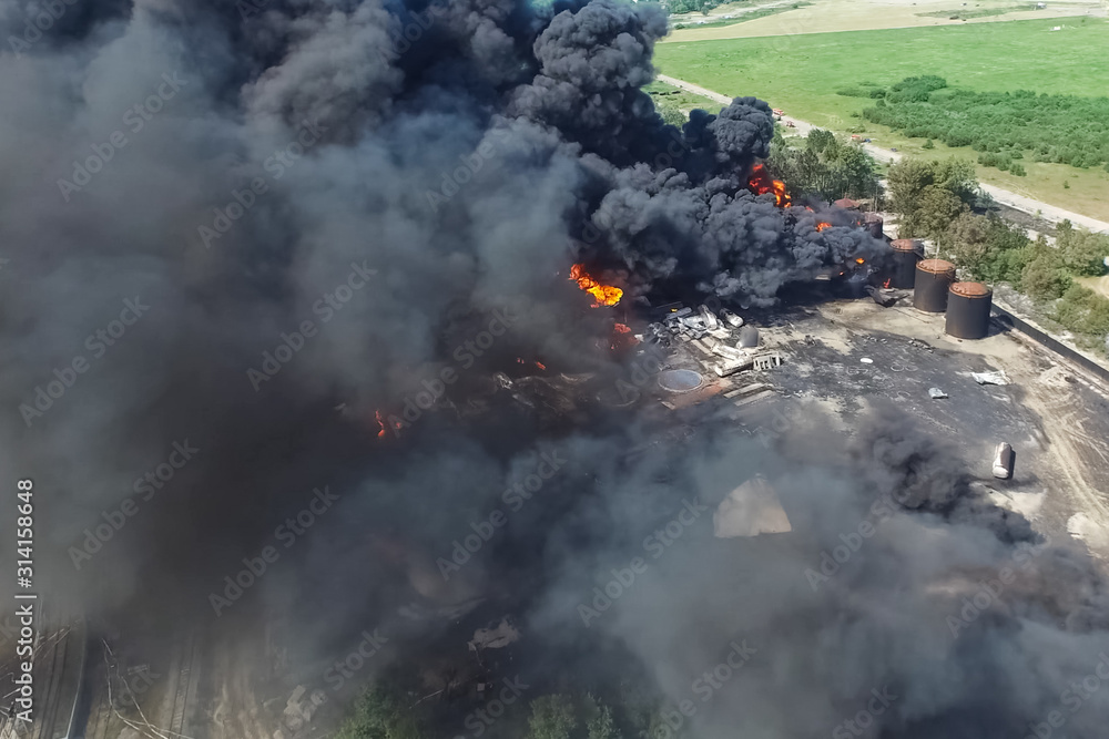 Oil storage fire. The tank farm is burning, black smoke is combu Oil storage fire. The tank farm is burning, black smoke is combu