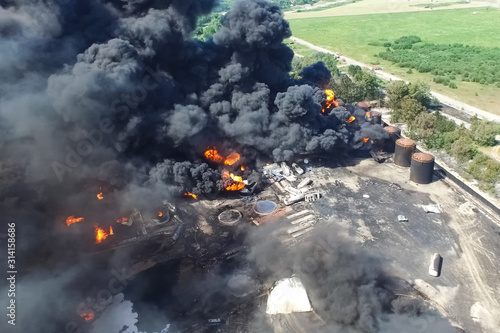 Oil storage fire. The tank farm is burning, black smoke is combu