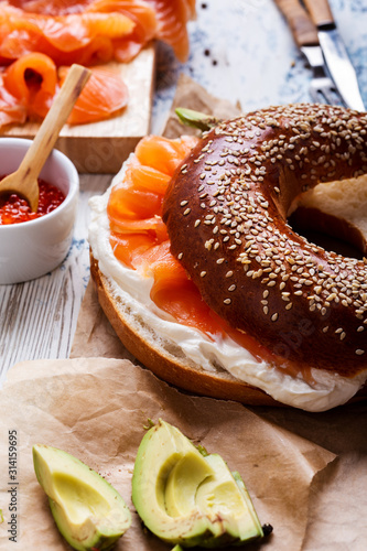 Cured salmon served  with cream  cheese, bagel, pot of  salmon caviar photo