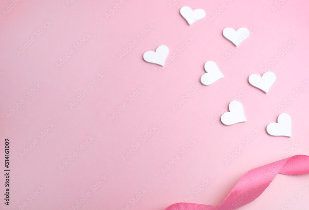 White hearts and ribbon on pink background. Love minimalist composition for Valentines day, Mothers day or healthcare concept. Copyspace.