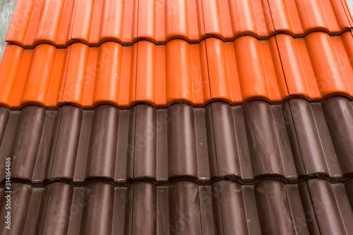 Samples of ceramic roofing tiles in a warehouse of a roofing mat