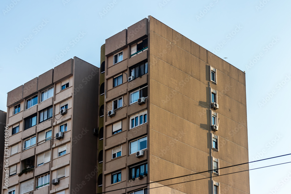 Fototapeta premium a wide architectural shoot from an old brown building - clear white sky as background