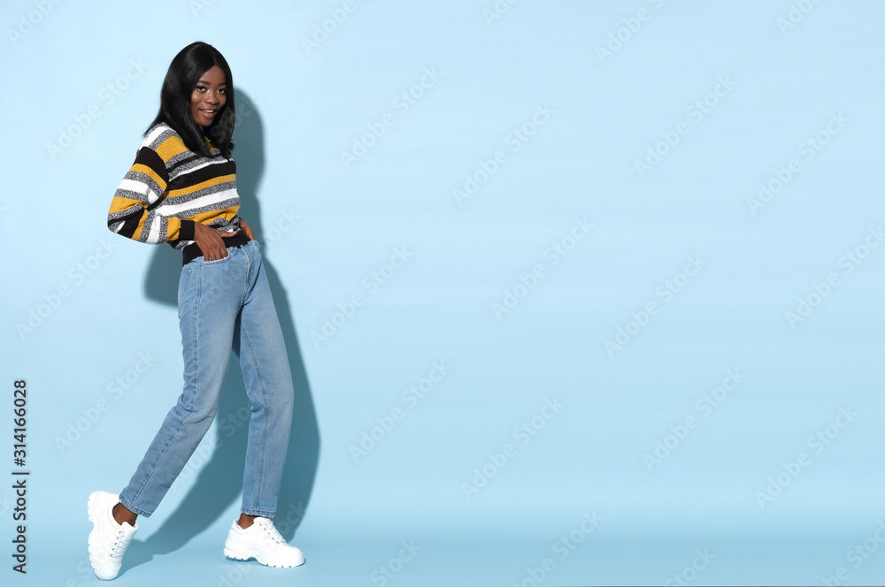 Fashion model in strike a pose wearing nice striped, colorful sweater. Fashion model in strike a pose wearing nice striped, colorful sweater.