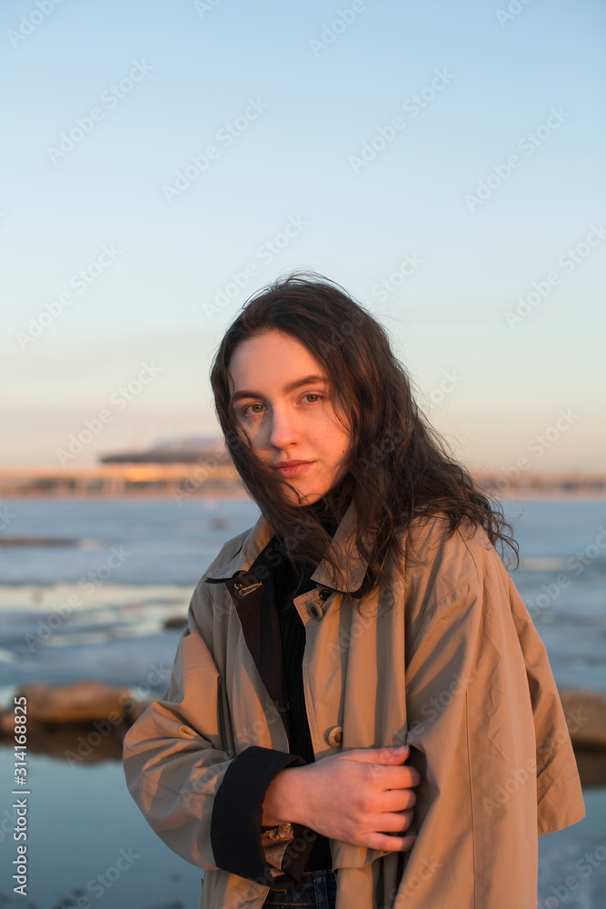 Portrait of beautiful young woman. Photoshoot series near river at the winter.