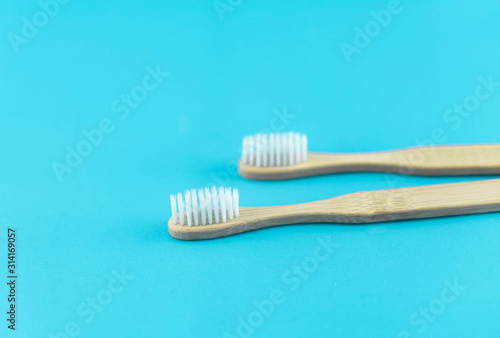 Close up wooden toothbrush on blue background  selective focus