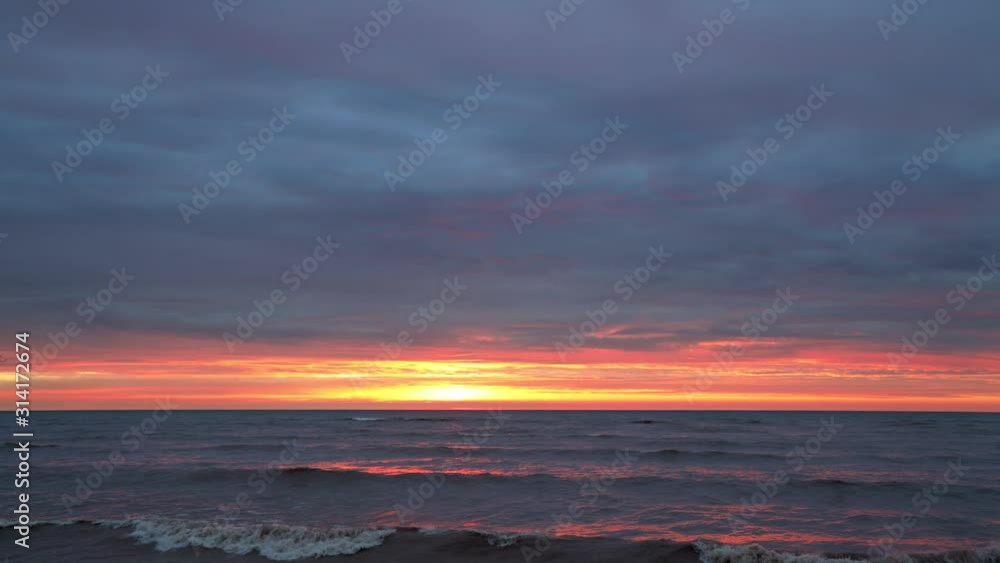 Fiery time lapse twilight and sunrise over Lake Michigan, makes a fantastic background for anything. Fiery time lapse twilight and sunrise over Lake Michigan, makes a fantastic background for anything.