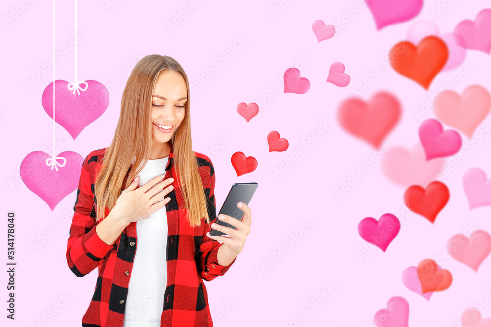 Young woman with phone isolated on pink background. Love, Valentines Day concept. Young woman with phone isolated on pink background. Love, Valentines Day concept.