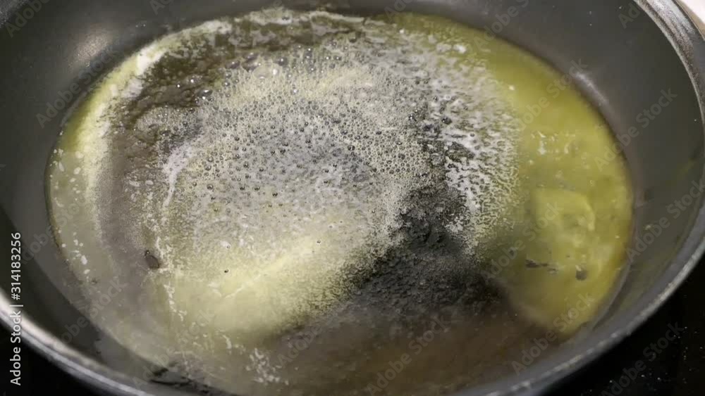 melting butter in a pan to bake pancakes. melting butter in a pan to bake pancakes.