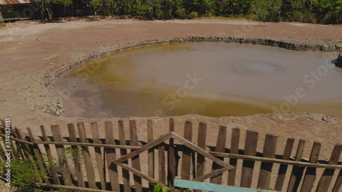 Closeup of L'eau Michel mud volcano bubbling from the center of the cone in Bunsee Trace penal, Trinidad and Tobago photo