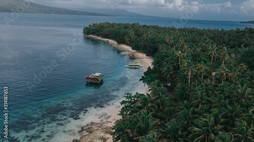 Amazing Aerial Landscape View of the Small Village Island in the Philippines. Top view of Crystal-clear Ocean Water with clear Blue Sky and Green Nature photo