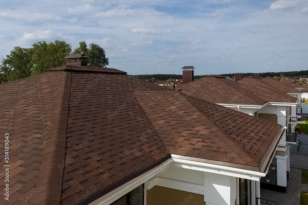 Bituminous tile for a roof. House with a roof from a bituminous