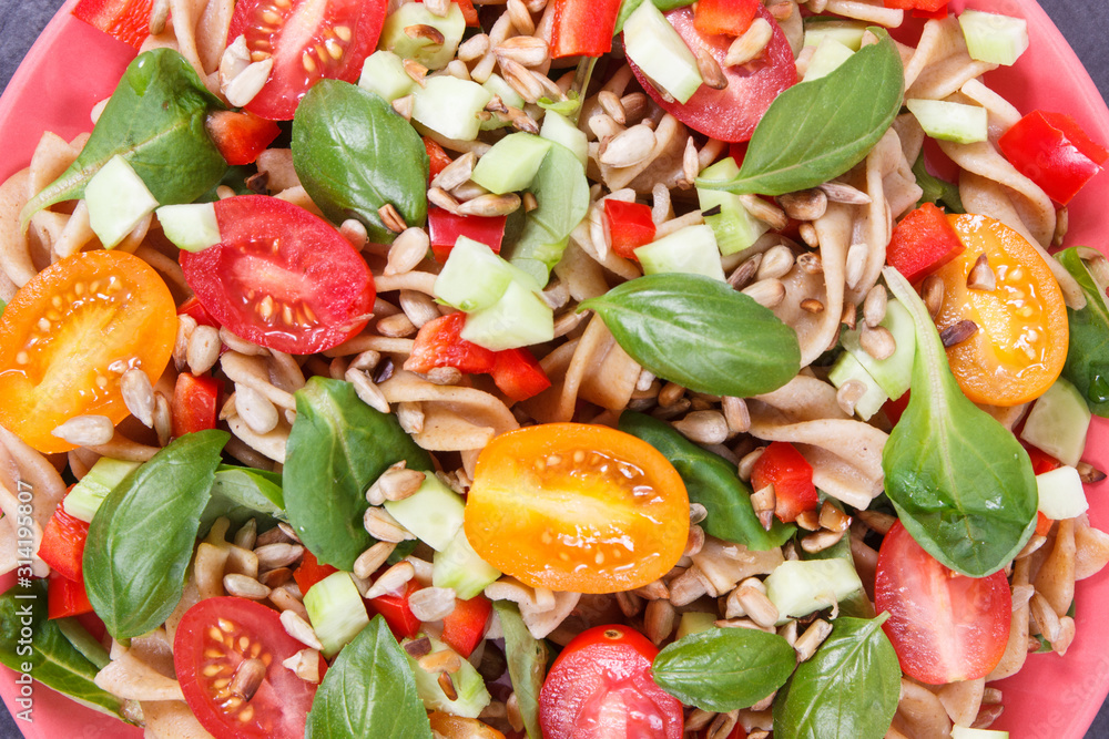 Salad with wholegrain pasta and vegetables as healthy meal containing vitamins and minerals