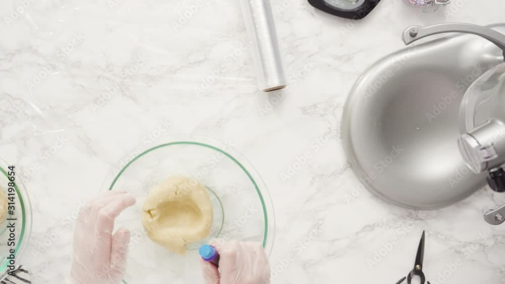 Step by step. Flat lay. Mixing food coloring into the cookie dough to bake red, white, and blue pinwheel sugar cookies. Step by step. Flat lay. Mixing food coloring into the cookie dough to bake red, white, and blue pinwheel sugar cookies.