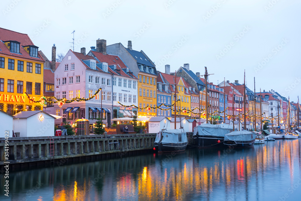 Nyhavn embankment with old ships along the Nyhavn Canal in Copenhagen, Denmark