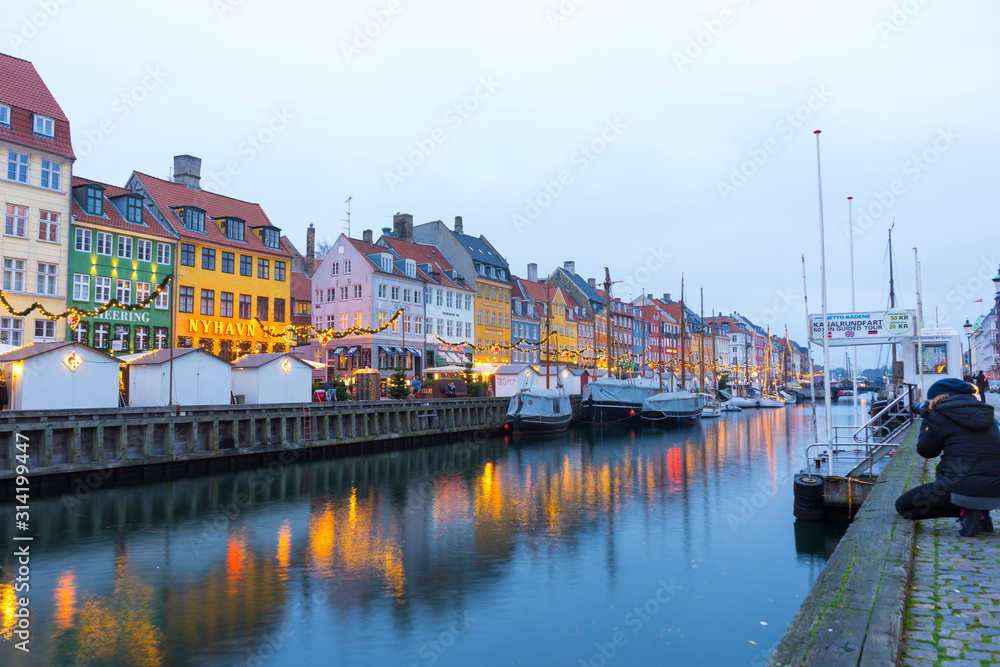 Fototapeta premium Nyhavn embankment with old ships along the Nyhavn Canal in Copenhagen, Denmark