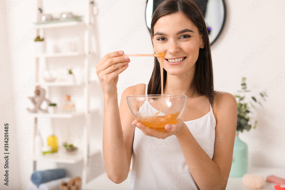 Beautiful young woman with sugaring paste in bathroom Beautiful young woman with sugaring paste in bathroom