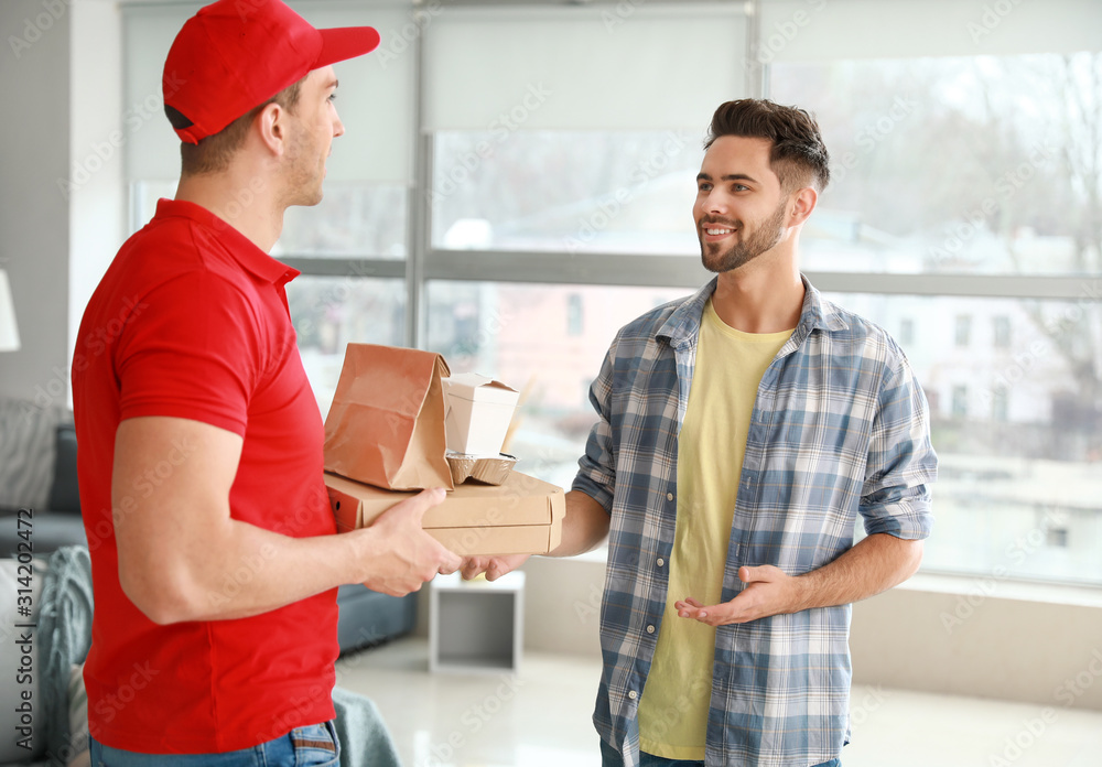 Man receiving order from courier of food delivery company Man receiving order from courier of food delivery company