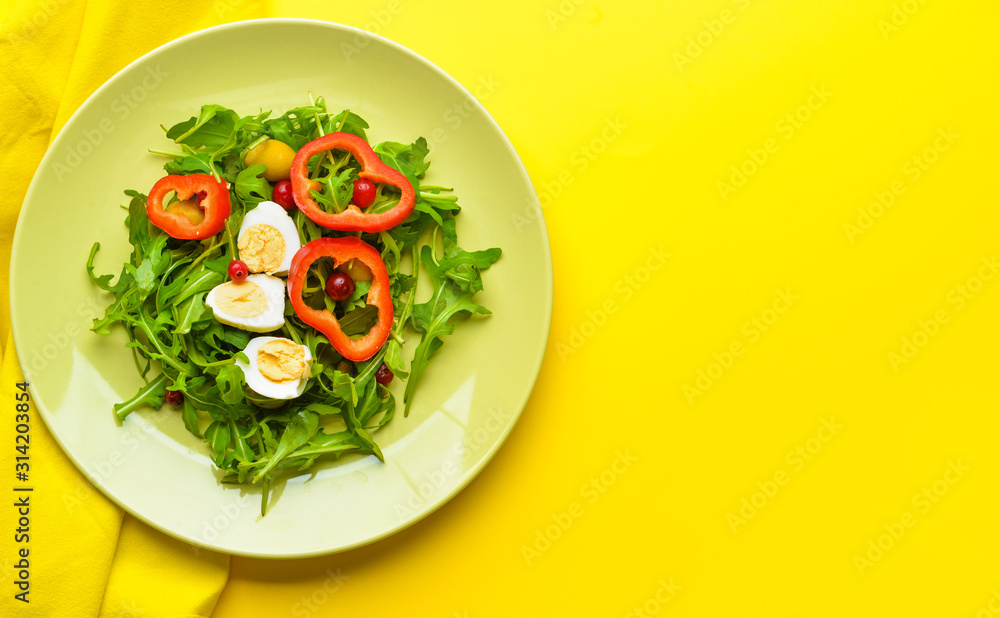 Plate with tasty salad on color background