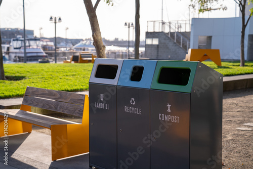 Landfill, recycle, compost combined waste trash bins in public park
