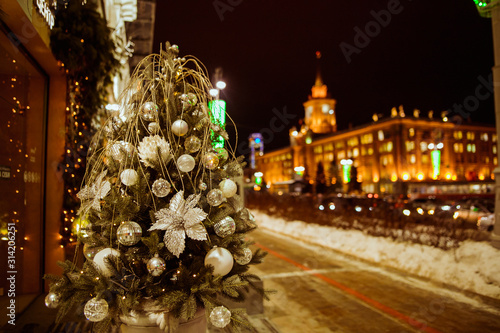 Christmas tree with lights outdoors at night in Kiev. Sophia Cathedral on background. New Year Celebration