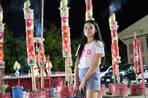 girl with candles on carousel at Chinese temple