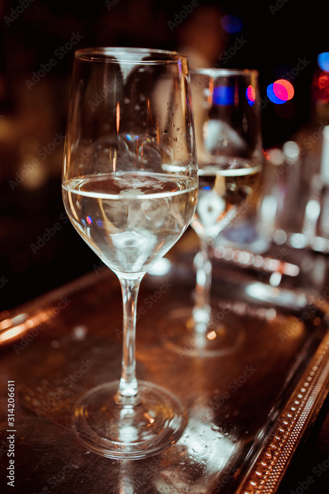 white wine in a glass against a bar white wine in a glass against a bar