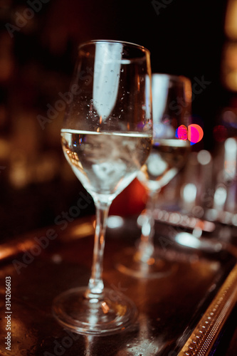 white wine in a glass against a bar