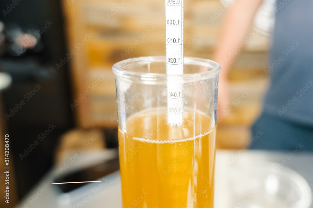 Measurement of alcohol content in beer. Hydrometer in glass of b Measurement of alcohol content in beer. Hydrometer in glass of b