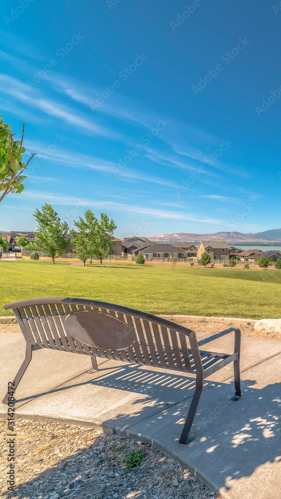 Vertical Park metal bench with view of lake snowy timpanogos mountains and blue sky