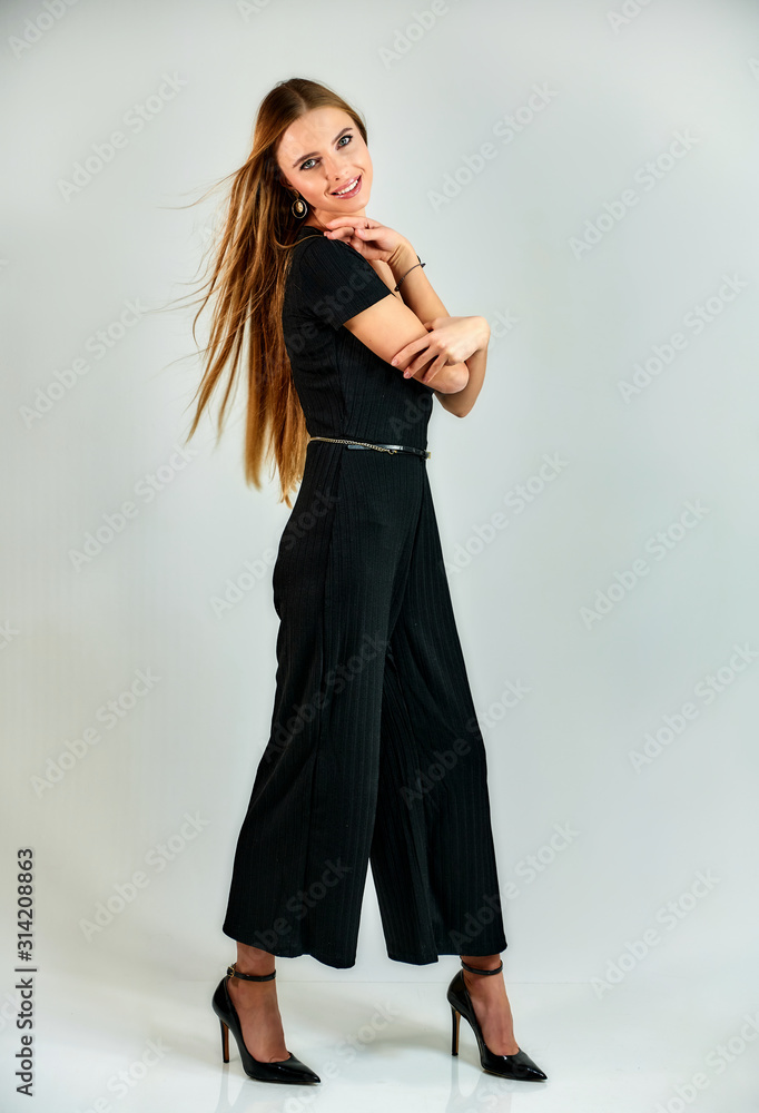 Full-length portrait of a pretty blonde girl with long hair and excellent make-up on a white background. Model student manager stands in different poses in front of the camera in the studio. Full-length portrait of a pretty blonde girl with long hair and excellent make-up on a white background. Model student manager stands in different poses in front of the camera in the studio.