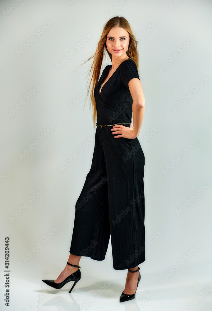 Model student manager stands in different poses in front of the camera in the studio. Full-length portrait of a pretty blonde girl with long hair and excellent make-up on a white background. Model student manager stands in different poses in front of the camera in the studio. Full-length portrait of a pretty blonde girl with long hair and excellent make-up on a white background.