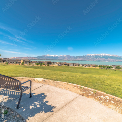 Square Park metal bench with view of lake snowy timpanogos mountains and blue sky