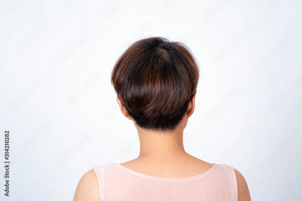 Portrait of an Asian short-haired woman turning her back on a white background Portrait of an Asian short-haired woman turning her back on a white background